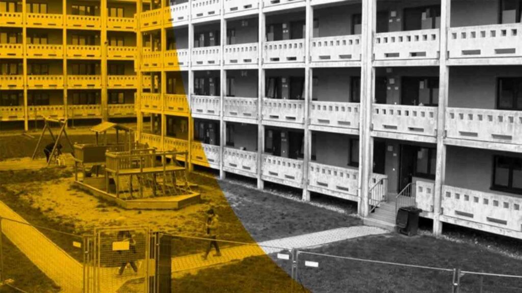 Mehrstöckiges Wohngebäude mit Spielplatz und gelbem Farbakzent, geometrische Ansicht.