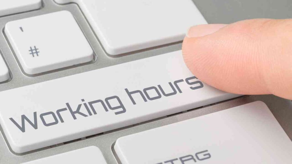 Finger drückt Working Hours-Taste auf Tastatur, Fokus auf Arbeitszeit-Management.