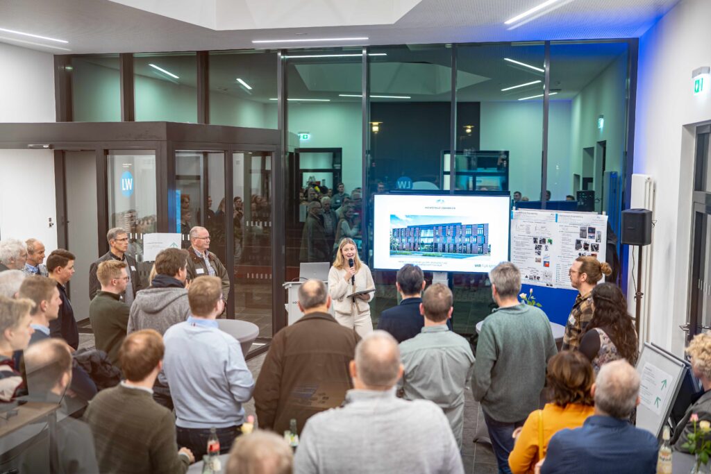 Eine Präsentation in einem modernen Raum mit einer Gruppe von Menschen, die einem Vortrag zuhören.