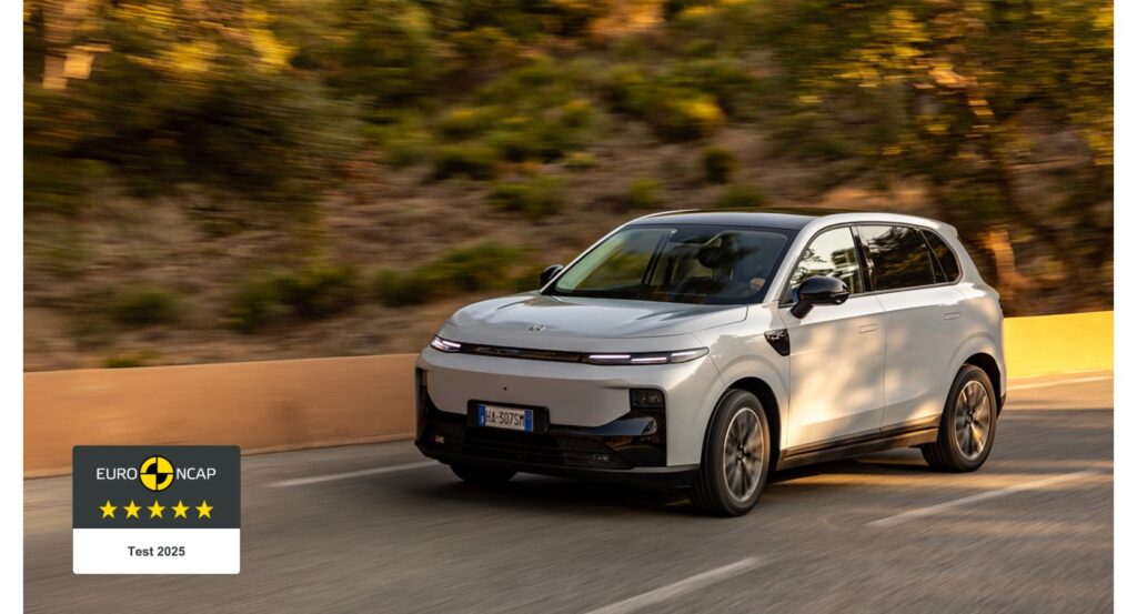 Weißer SUV von Leapmotor, Modell B10, fährt auf einer Straße mit bewaldetem Hintergrund.