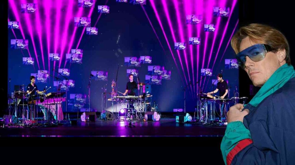 Musiker auf der Bühne mit Instrumenten und bunten Lichtern während einer Live-Performance.