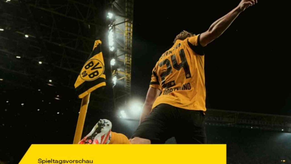 Spieler von Borussia Dortmund in gelbem Trikot mit der Nummer 24, jubelnd vor einer Ecke mit Vereinsflagge.