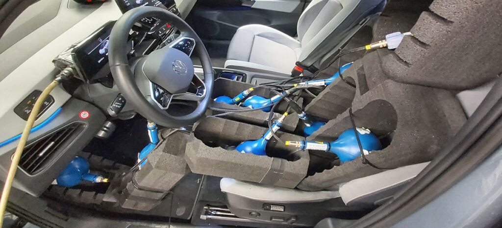 Innenansicht eines Fahrzeugs mit blauen Testgeräten und Schaumstoffpolsterung zur Sicherheitsprüfung.