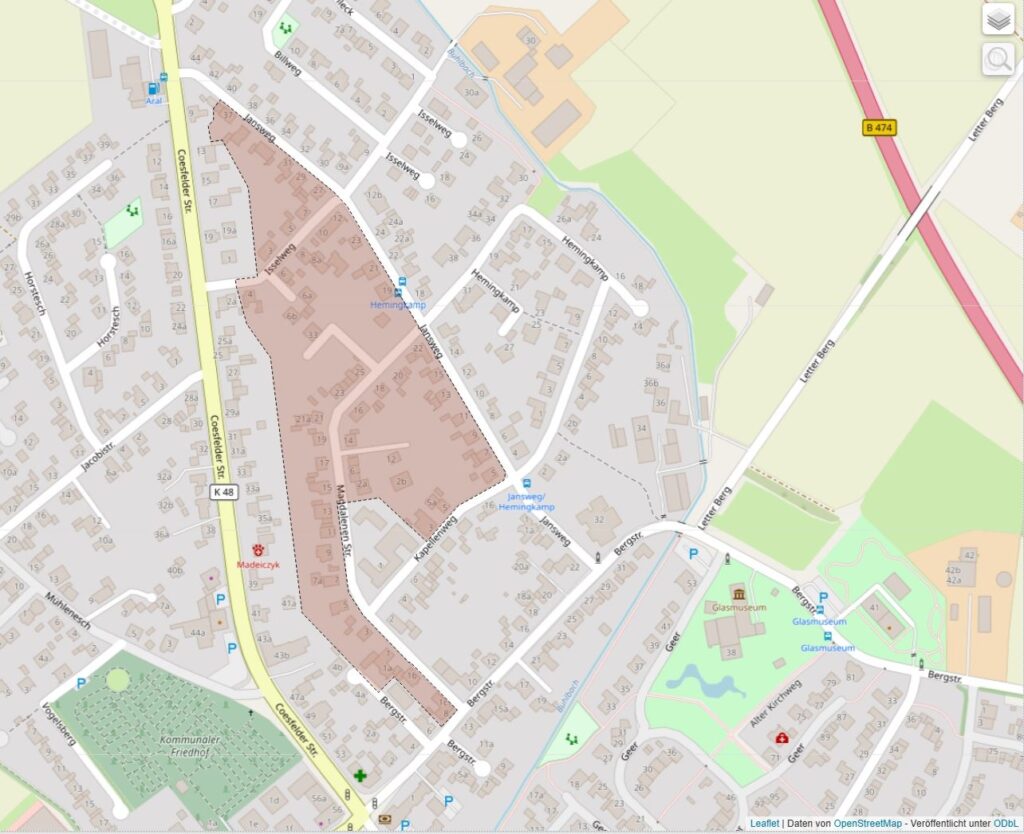 Stadtplan mit Straßen, Gebäuden und markierten Bereichen in einem klaren, detaillierten Design.
