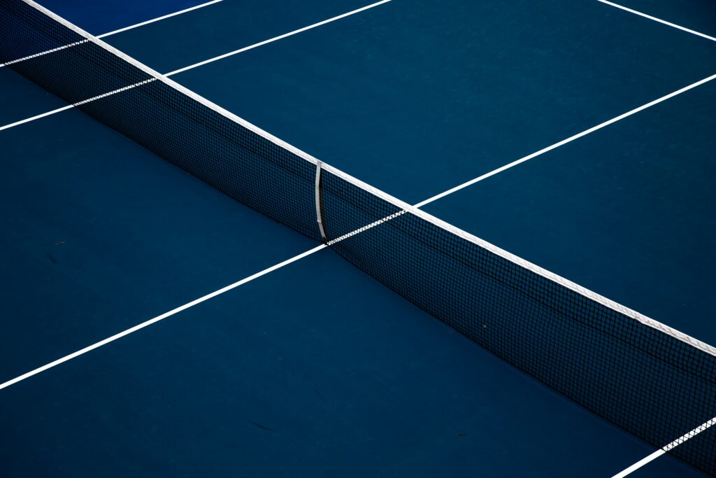 Blauer Tennisplatz mit Netz, Symbolbild für Sportförderung