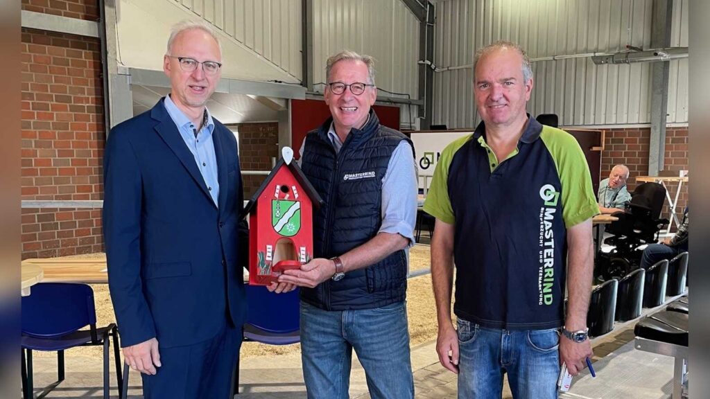 Bürgermeister Helmut Höke gratuliert Auktionator Michael Hellwinkel und Standortleiter Ludwig Ginten