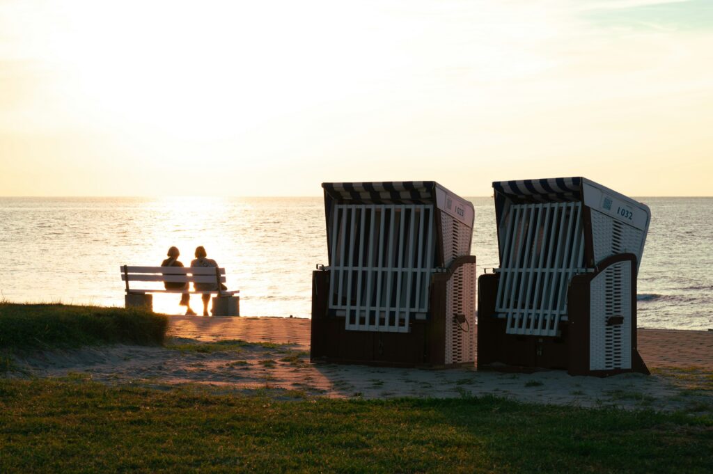 Zwei Strandkörbe stehen am Abend an der Nordseeküste in Ostfriesland