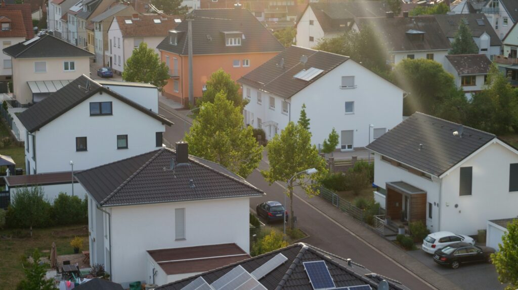 Luftaufnahme eines Wohngebiets mit Solaranlagen auf den Dächern, Symbolbild für energetische Quartiersentwicklung