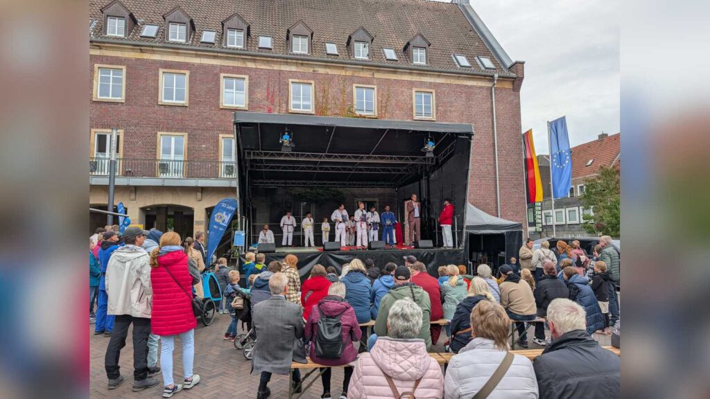Publikum vor der Bühne auf dem Dülmener Marktplatz, auf der eine Gruppe in Judoanzügen auftritt