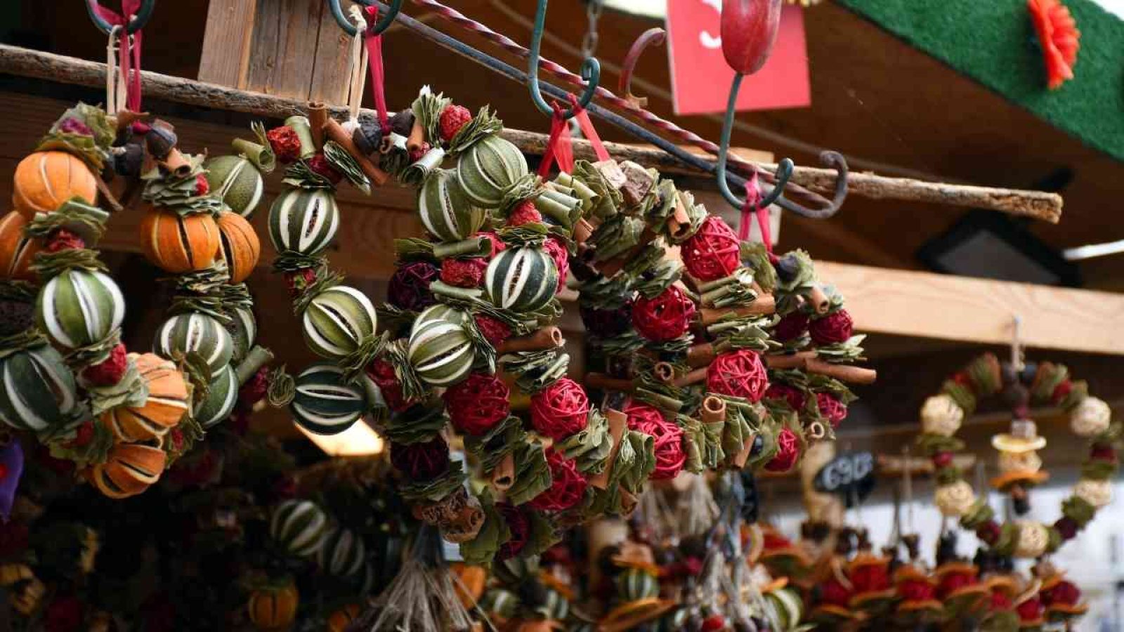 Adventsmarkt Dekorative Kränze aus getrockneten Früchten und Gewürzen auf einem Weihnachtsmarktstand.