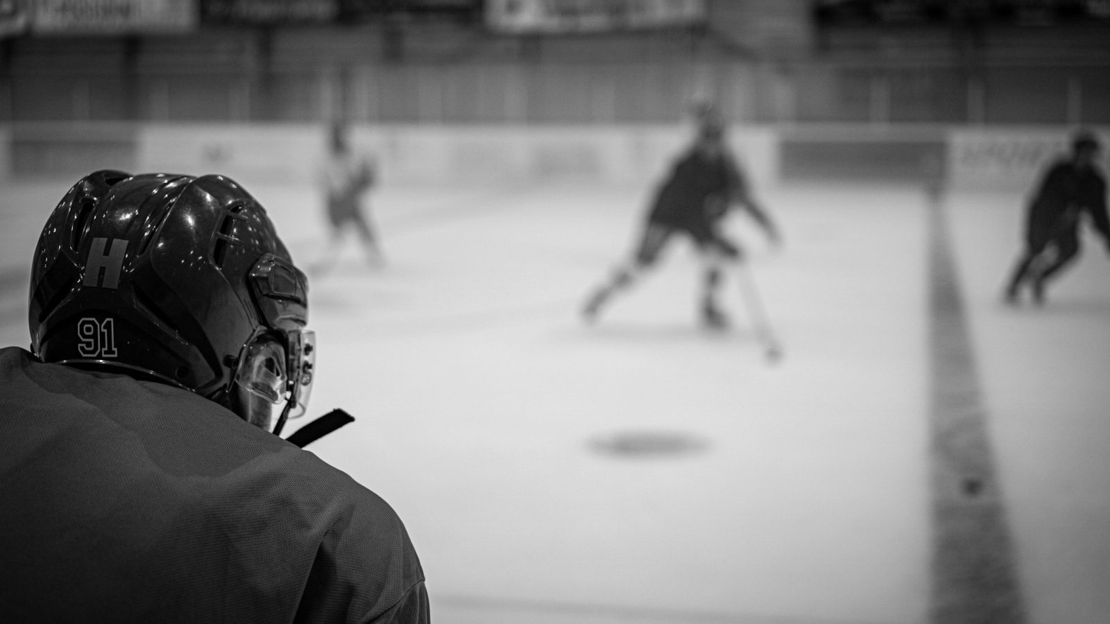 Eishockeyspieler im Zweikampf um den Puck in einer Eishalle